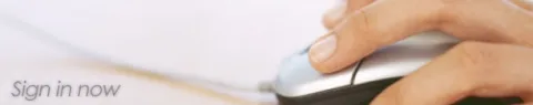 A hand rests on a mouse as though in use.